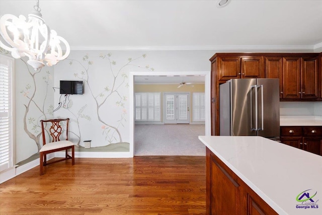 kitchen featuring decorative light fixtures, wood-type flooring, ceiling fan with notable chandelier, and high quality fridge