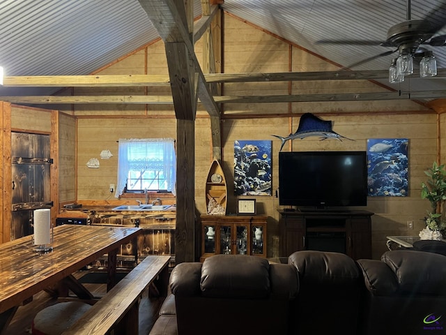 living room featuring sink, wooden walls, vaulted ceiling, and ceiling fan