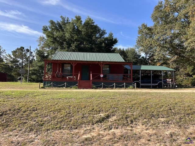 view of front of house with a front lawn and a carport