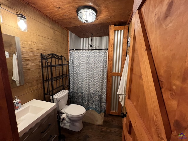 bathroom featuring toilet, vanity, wooden ceiling, and wooden walls