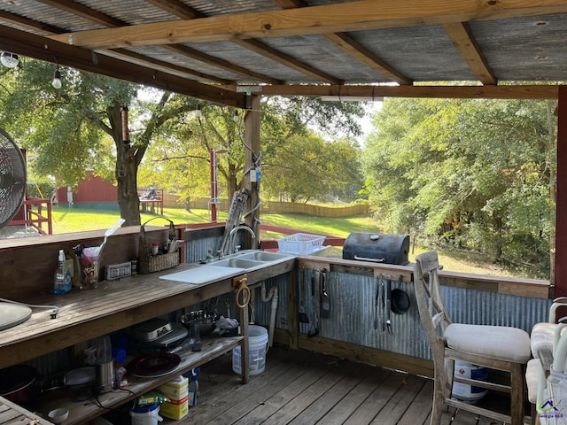 deck featuring a yard, grilling area, and sink