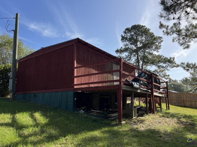 back of house with a yard and a deck