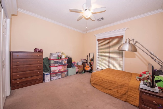 carpeted bedroom with ornamental molding and ceiling fan