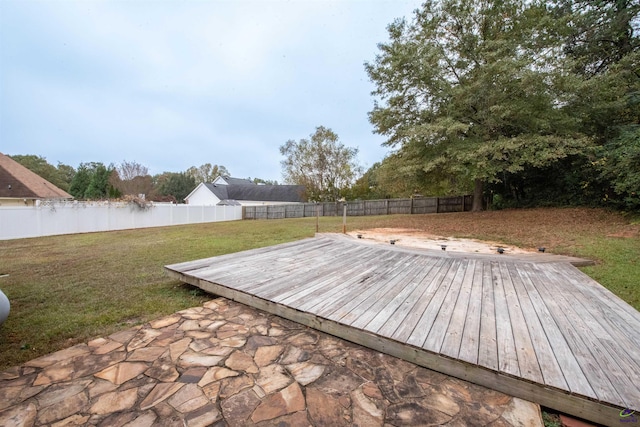 wooden deck featuring a patio and a yard