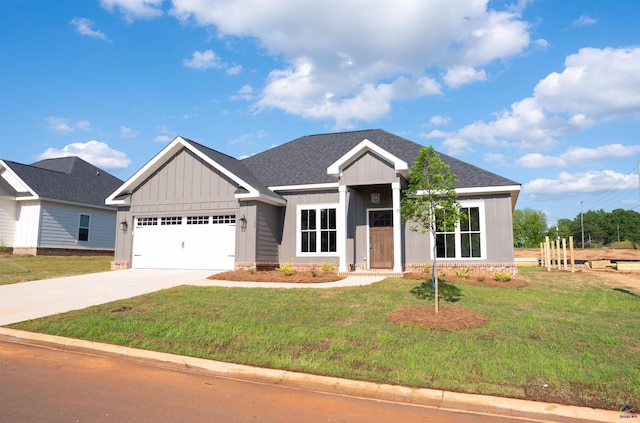100 Saraland Trl, Perry, GA 31069 - view of front of home featuring board and batten siding, a garage, a front yard, and concrete driveway