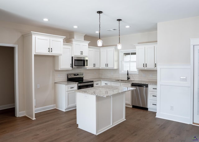 100 Saraland Trl, Perry, GA 31069 - kitchen featuring stainless steel appliances, a sink, white cabinets, decorative backsplash, and recessed lighting