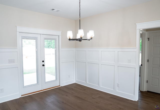 100 Saraland Trl, Perry, GA 31069 - unfurnished dining area with a decorative wall, a chandelier, french doors, wainscoting, and dark wood-style flooring