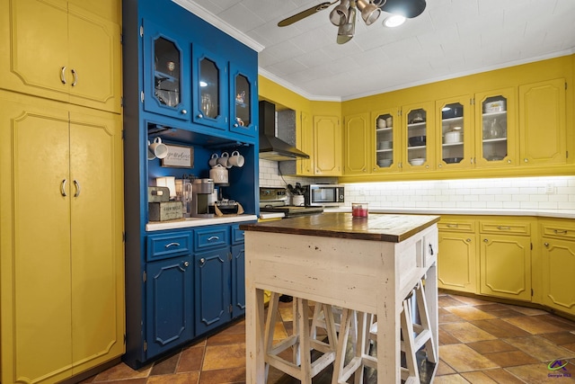 kitchen with wood counters, backsplash, range with electric cooktop, ornamental molding, and wall chimney range hood