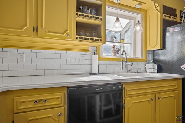 kitchen with decorative backsplash, light stone countertops, and black dishwasher