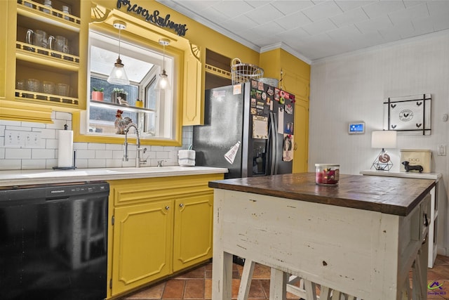 kitchen with sink, black dishwasher, stainless steel refrigerator with ice dispenser, crown molding, and pendant lighting