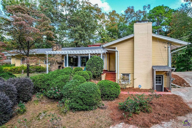 view of front of property with a pergola