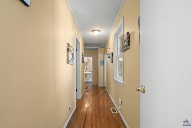 hall featuring wood-type flooring and ornamental molding