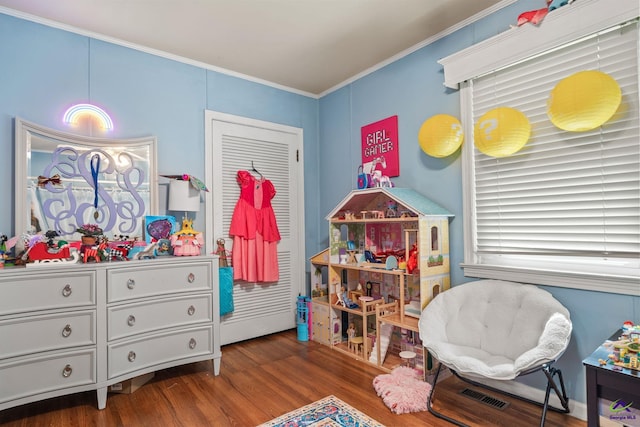 bedroom with hardwood / wood-style flooring and crown molding