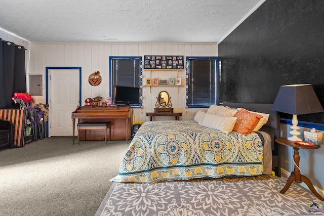 bedroom with electric panel, wooden walls, ornamental molding, a textured ceiling, and carpet floors