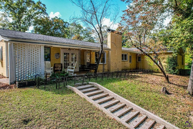 rear view of house with a yard