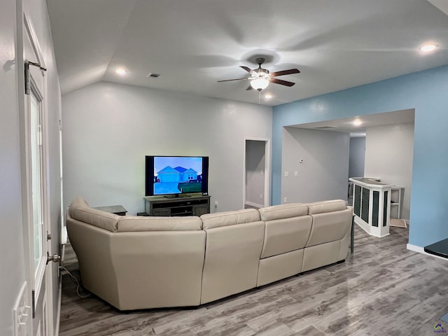 living room with hardwood / wood-style flooring, ceiling fan, and lofted ceiling