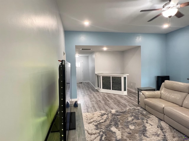 living room featuring light wood-type flooring and ceiling fan