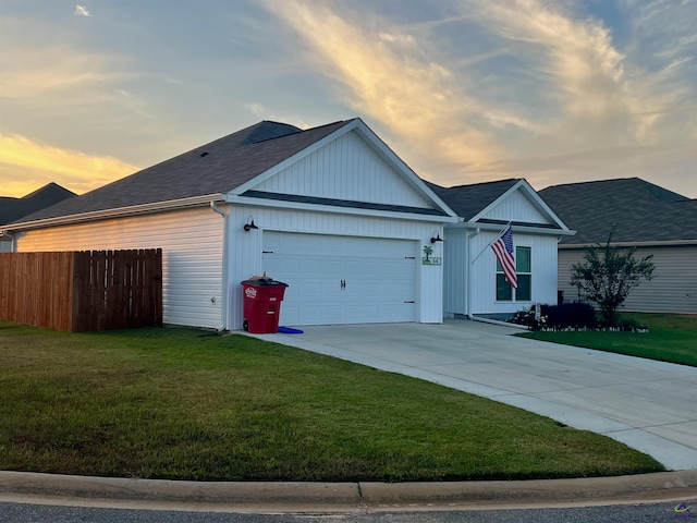 single story home with a garage and a yard