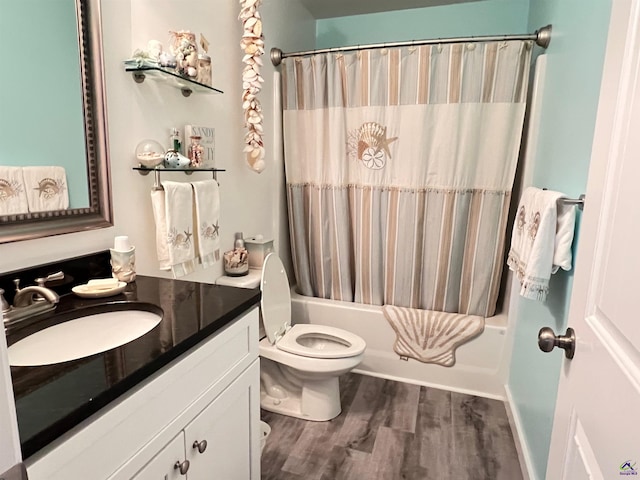 full bathroom featuring vanity, hardwood / wood-style flooring, toilet, and shower / tub combo