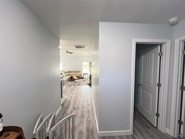 corridor with hardwood / wood-style flooring