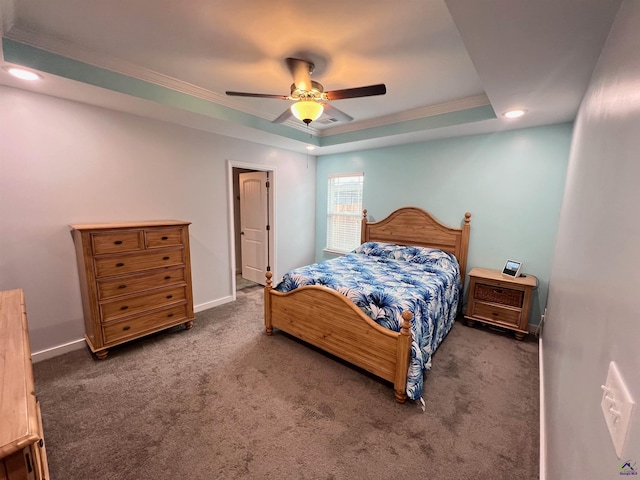 carpeted bedroom featuring ceiling fan, crown molding, and a tray ceiling