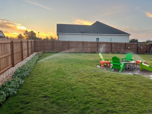 yard at dusk featuring an outdoor fire pit and a patio area