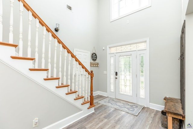 foyer entrance featuring a high ceiling and hardwood / wood-style floors