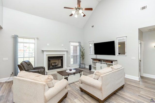 living room featuring high vaulted ceiling, ceiling fan, and light hardwood / wood-style flooring