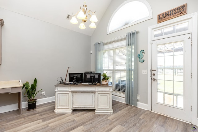 office with high vaulted ceiling, a chandelier, and light hardwood / wood-style flooring