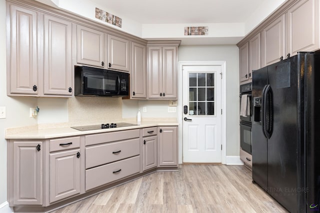 kitchen featuring light hardwood / wood-style flooring and black appliances