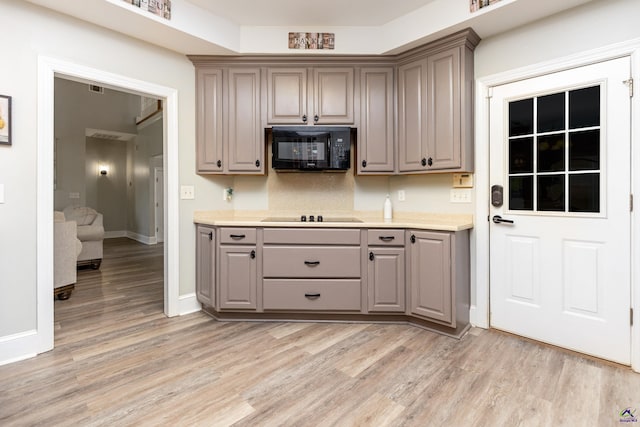 kitchen featuring black appliances and light hardwood / wood-style floors