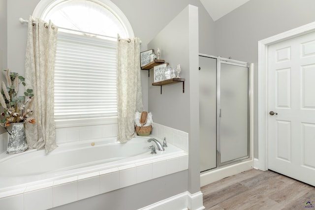 bathroom with hardwood / wood-style floors, a wealth of natural light, an enclosed shower, and vaulted ceiling