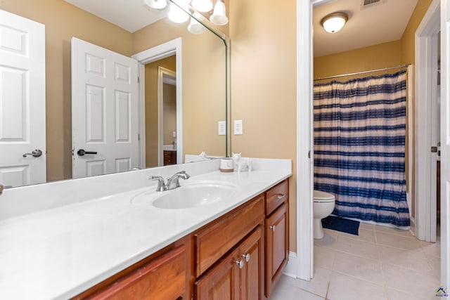 bathroom with toilet, a shower with curtain, vanity, and tile patterned flooring