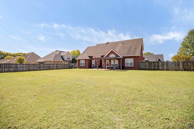 back of house featuring a lawn and a patio area