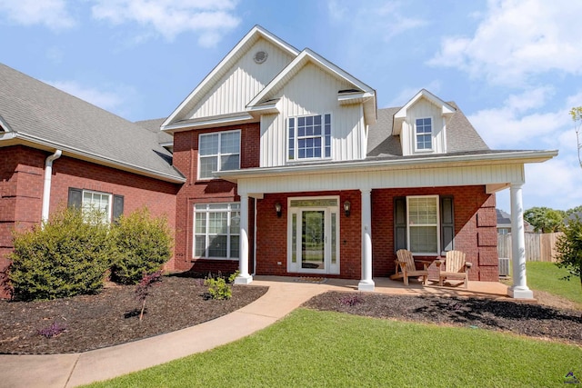 view of front of house with a porch and a front yard