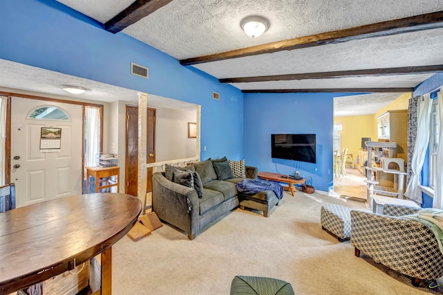 carpeted living room featuring a textured ceiling and beam ceiling