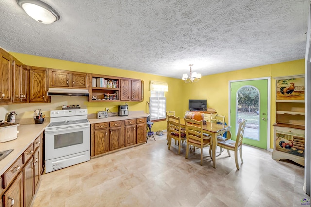 kitchen featuring a textured ceiling, decorative light fixtures, a healthy amount of sunlight, and white electric range oven