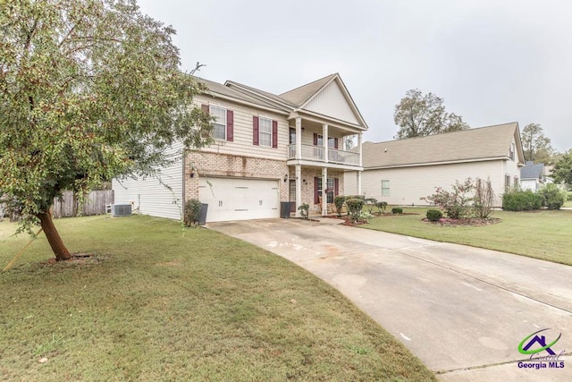 view of front of home with a balcony, a garage, cooling unit, and a front yard