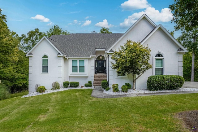 ranch-style house featuring a front lawn