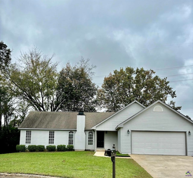 ranch-style home featuring a garage and a front yard