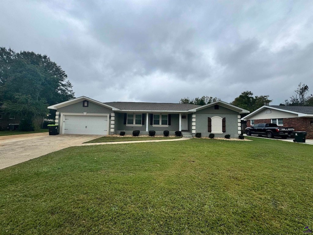 ranch-style home featuring a garage and a front lawn