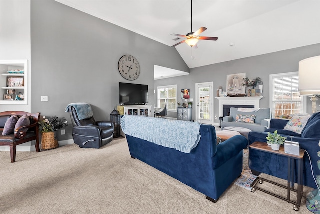 carpeted living room featuring plenty of natural light, lofted ceiling, and ceiling fan