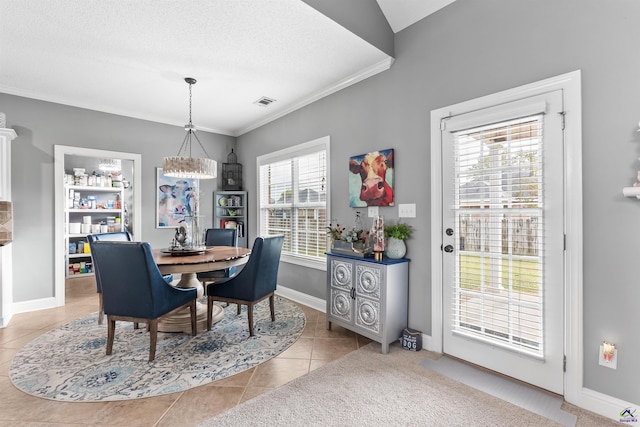 dining room with light tile patterned floors and crown molding