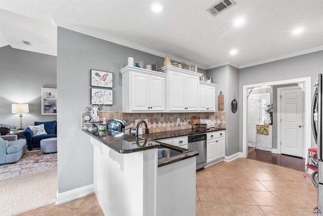 kitchen with kitchen peninsula, dishwasher, white cabinets, and sink