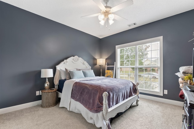 bedroom featuring ceiling fan and light carpet