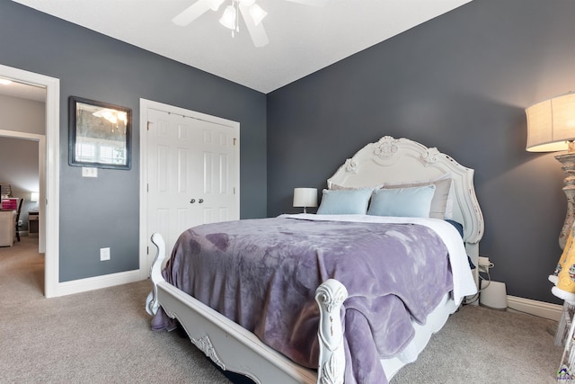 carpeted bedroom with ceiling fan and a closet