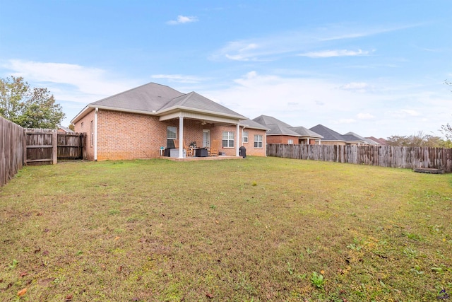 rear view of property featuring a lawn