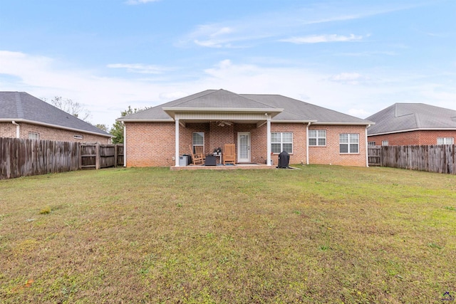 rear view of property with a patio area and a yard