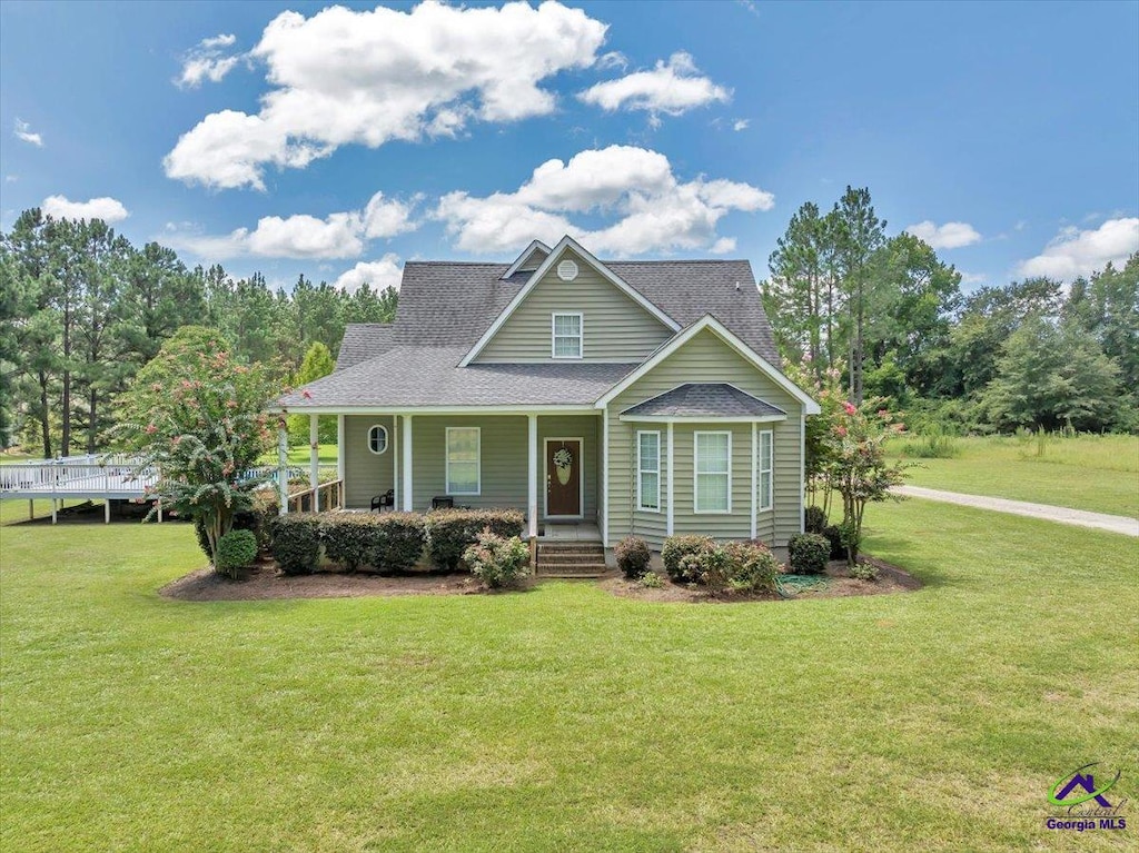 view of front of home with a porch and a front lawn