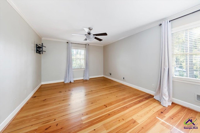 empty room with hardwood / wood-style floors, ceiling fan, and crown molding